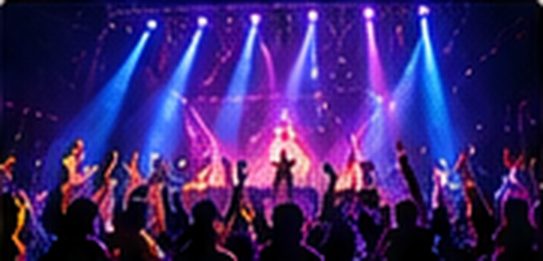 Live stage with coloured beams and a cheering crowd
